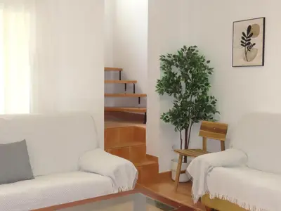 a living room with two white couches and a plant at Casa del Prado in Navarrés