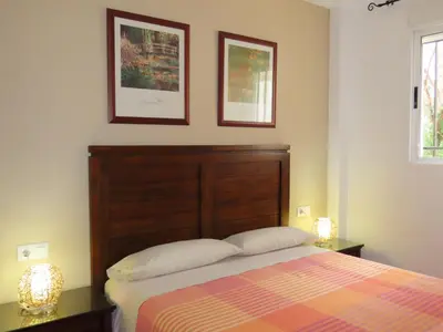 a bedroom with a bed and two pictures on the wall at Casa del Prado in Navarrés