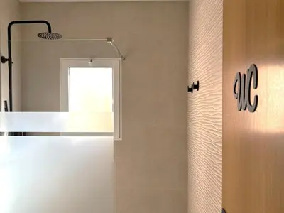 a bathroom with a white refrigerator and a window at Casa del Prado in Navarrés