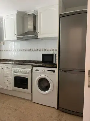 a kitchen with a washing machine and a refrigerator at Apartamento en Canet Berenguer Valencia in Canet de Berenguer