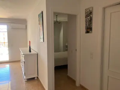 a hallway with a room with a bed and a candle at Apartamento en Canet Berenguer Valencia in Canet de Berenguer
