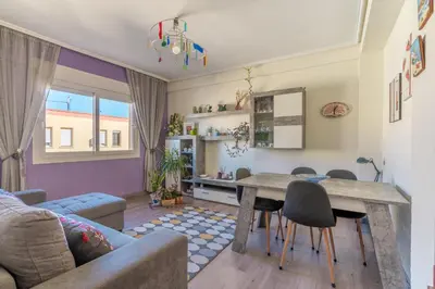 a living room with a table and chairs at Invalencia - Begis Flat Cabanyal in Valencia