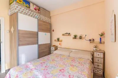 a bedroom with a bed with a floral bedspread at Invalencia - Begis Flat Cabanyal in Valencia