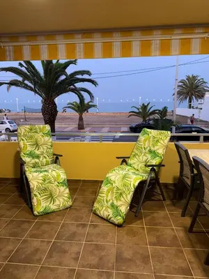 two chairs and a table with a view of the beach at Oceanfront Ideal for couples and teleworking in Moncófar