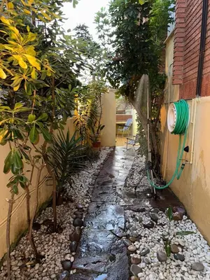 a garden path with a hose attached to a building at Oceanfront Ideal for couples and teleworking in Moncófar