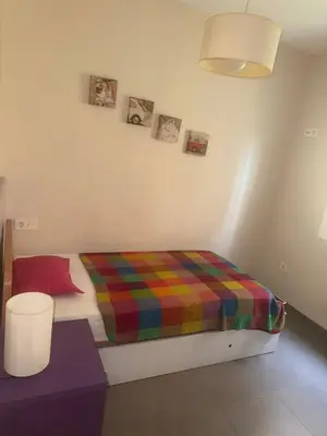 a room with a bed with a colorful blanket at Oceanfront Ideal for couples and teleworking in Moncófar