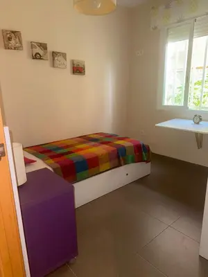 a bedroom with a bed with a colorful blanket at Oceanfront Ideal for couples and teleworking in Moncófar