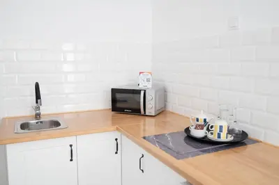 a kitchen with a sink and a microwave at M&A Hostal en Onda in Bechí