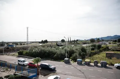 a parking lot with cars parked in a parking lot at M&A Hostal en Onda in Bechí