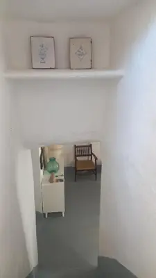 a white room with a table and a chair at El Cap de Pedra in Calles