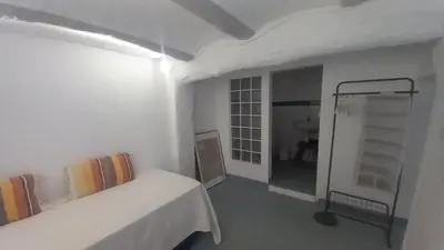 a white room with a bed and a walk in shower at El Cap de Pedra in Calles