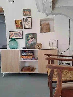 a shelf in a room with a table and a chair at El Cap de Pedra in Calles