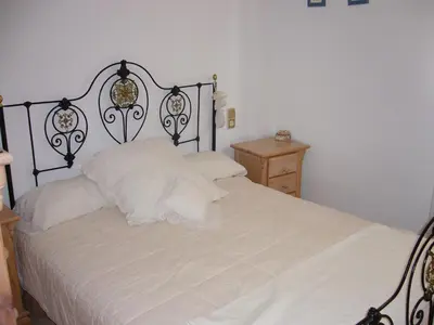 a bedroom with a black and white bed with white pillows at Primer piso de 2 habitaciones en unifamiliar frente al mar in El Brosquil