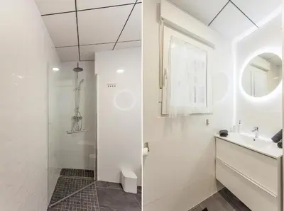 a white bathroom with a shower and a sink at Apartment Ruzafa Tomasos in Valencia