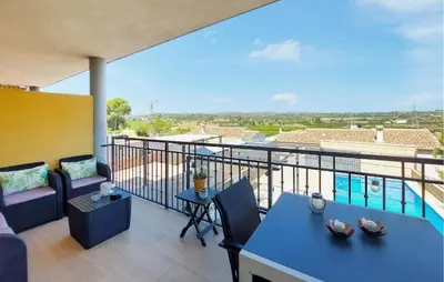 a balcony with a couch and a table at Awesome Home In Turis in Turís