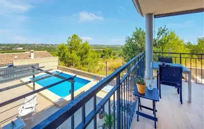 a balcony with a swimming pool on a house at Awesome Home In Turis in Turís