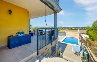 a balcony of a house with a swimming pool at Awesome Home In Turis in Turís