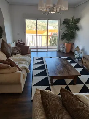 a living room with a couch and a coffee table at Quesa Tranquil Valencia in Quesa