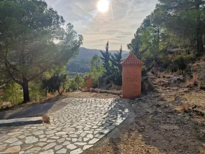 a stone path with a brick pillar on a hill at Quesa Tranquil Valencia in Quesa