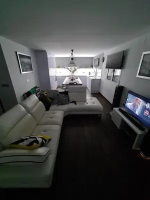 a living room with a couch and a flat screen tv at Quesa Tranquil Valencia in Quesa