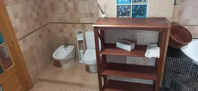 a bathroom with a toilet and a sink and a tub at Casa Paola in Buñol