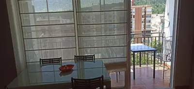 a glass table in front of a large window at Casa Paola in Buñol