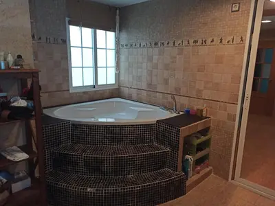 a bathroom with a bath tub in a room at Casa Paola in Buñol