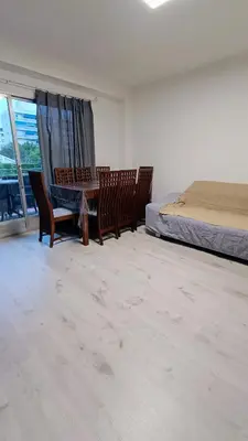 a bedroom with a table and chairs and a bed at Disfruta en familia junto al mar in Playa Pobla de Farnals