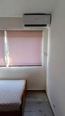a bedroom with a bed and a tv on a wall at Disfruta en familia junto al mar in Playa Pobla de Farnals