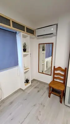 a room with a chair and a large window at Disfruta en familia junto al mar in Playa Pobla de Farnals