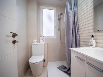 a bathroom with a toilet and a sink and a window at Apartment Ruzafa Market 6C in Valencia