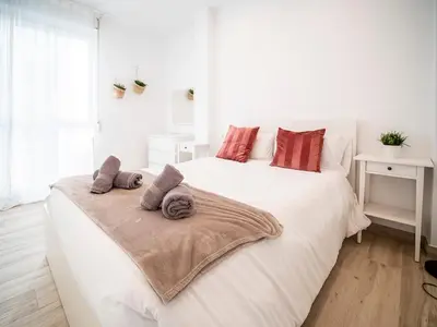 a bedroom with a white bed with towels on it at Apartment Ruzafa Market 6C in Valencia