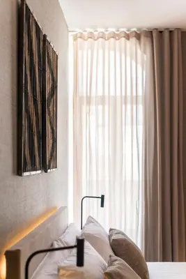 a bedroom with a bed and a window at Blanq Gran vía in Valencia