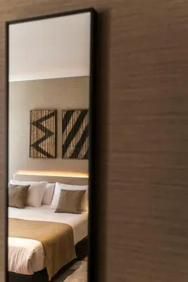 a bedroom with a bed and a mirror at Blanq Gran vía in Valencia