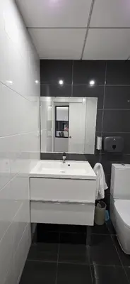a white bathroom with a sink and a mirror at Mi Huésped 130 Valencia, Aeropuerto Manises in Manises