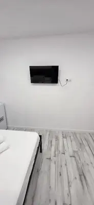 a white room with a bed and a tv on the wall at Mi Huésped 130 Valencia, Aeropuerto Manises in Manises