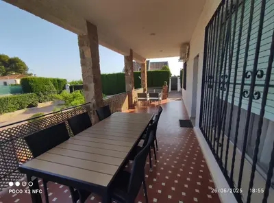 a wooden table and chairs on a balcony at Chalet en el parque natural de la Calderona in Náquera