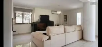 a living room with a couch and a television at Torrent Veda Chalet in Torrent