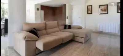 a living room with a couch and a table at Torrent Veda Chalet in Torrent