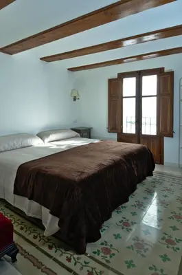 a bedroom with a large bed with a brown blanket at Casa Rural 