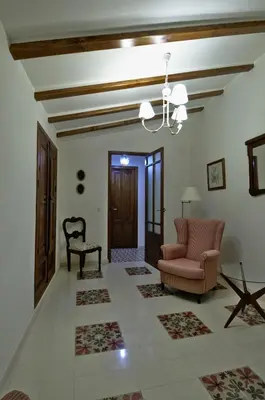 a living room with a couch and a chair at Casa Rural 