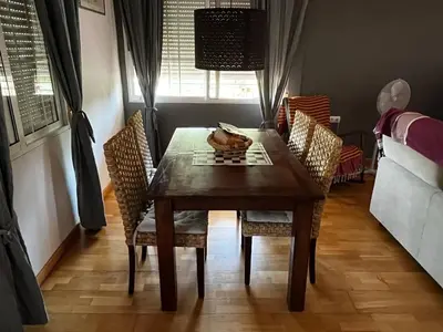 a dining room with a table and chairs and a window at Casa Mallaeta in Puebla de Vallbona