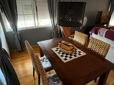 a dining room with a wooden table and chairs at Casa Mallaeta in Puebla de Vallbona