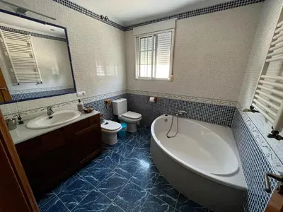 a bathroom with a tub and a sink and a toilet at Casa Mallaeta in Puebla de Vallbona