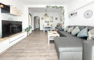 a living room with a couch and a tv at Nice Apartment In Puebla De Farnals in Puebla de Farnals