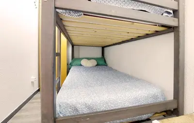 a small bunk bed with a teddy bear sitting on it at Nice Apartment In Puebla De Farnals in Puebla de Farnals