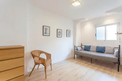 a living room with a bench and a window at Apartment with terrace in Extramurs in Valencia