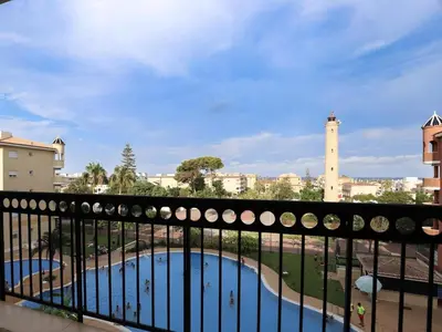 a view of a pool from a balcony at Spectacular views of the sea and the lighthouse in Canet de Berenguer