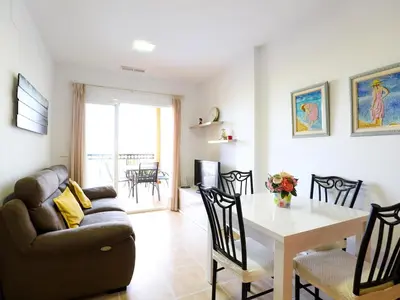 a living room with a couch and a table at Spectacular views of the sea and the lighthouse in Canet de Berenguer