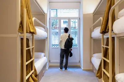 a bathroom with a shower with a toilet paper dispenser at Camila Hostel Valencia in Valencia